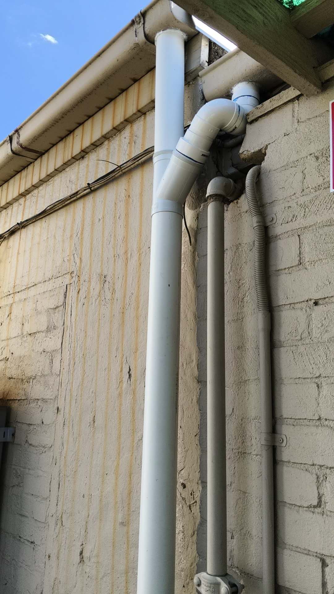 Owner-supplied project photo showing a completed exterior drainage pipe installation