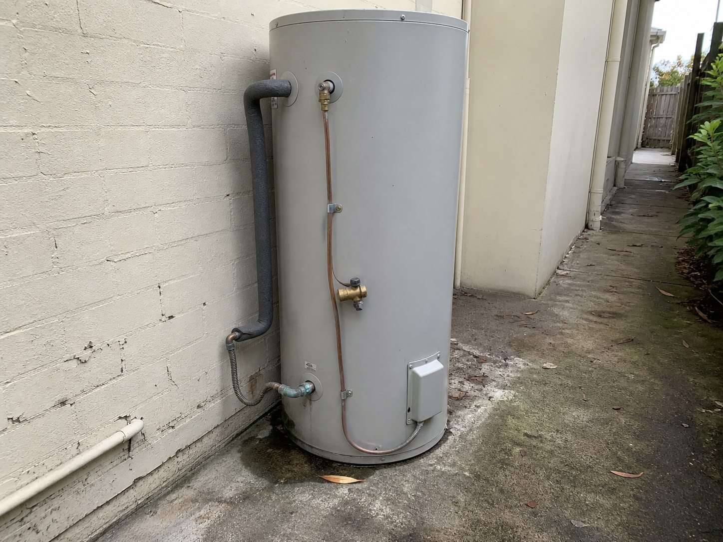Outdoor hot-water unit with corrosion and moisture around a lower connection